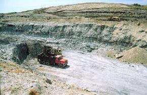 This is one of the clay pits for the Hebron Brick Company in northwestern Morton County. The bricks are produced from a mixture of white and gray clay 
								from the Bear Den Member, sandstone from the overlying Camels Butte Member, and recycled bricks. The Hebron Brick Company presently mines approximately 40,000 tons of clay per year to produce 20
								million bricks. 