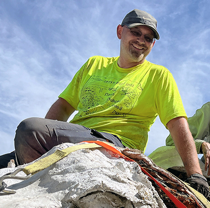 Clint Boyd sitting on a large plaster field jacket.