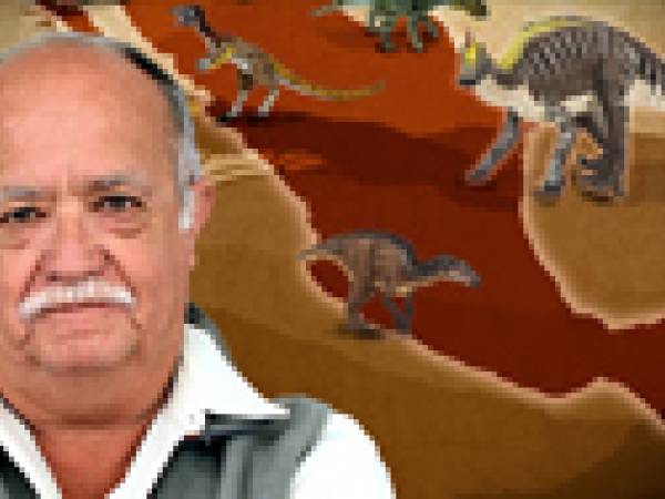 Rene standing in front of a map with dinosaurs from Mexico