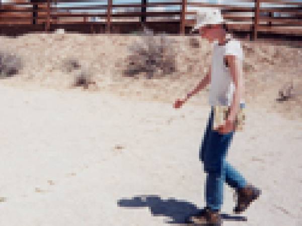 A young Becky walking near dinosaur footprints in Wyoming