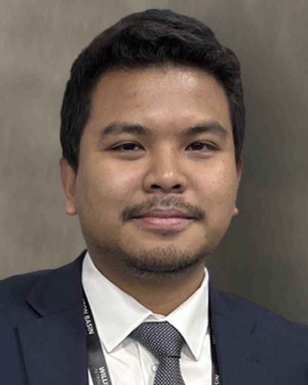 Headshot of Ismail Faruqi wearing a navy suit and dark gray tie.