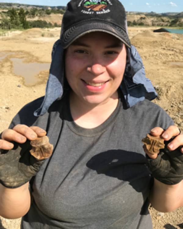 Alex Gardner holding fossils