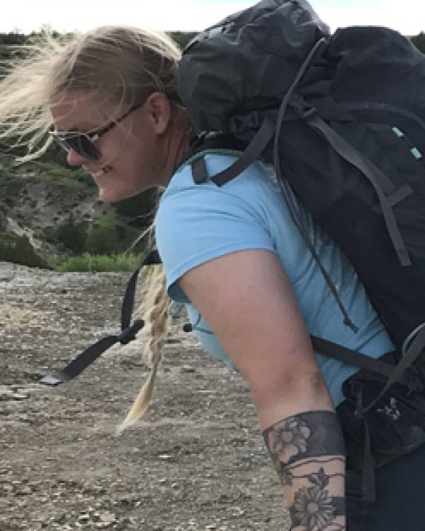 Kelsey Mills wearing a large backpack