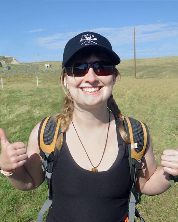 Photo of a woman giving two thumbs up.