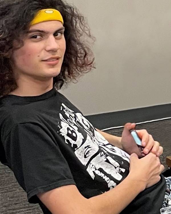 Photo of a man wearing a black tshirt.