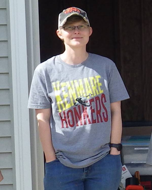 Photo of a person standing in front of a garage door.
