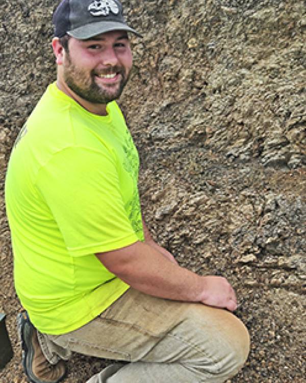 Skylor Booth sitting in the dirt