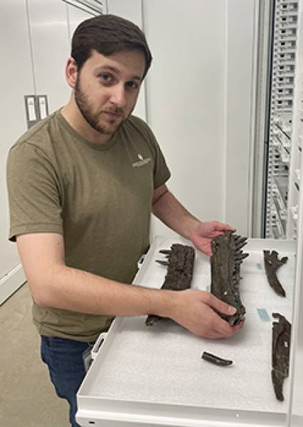 Patrick holding fossils in the lab