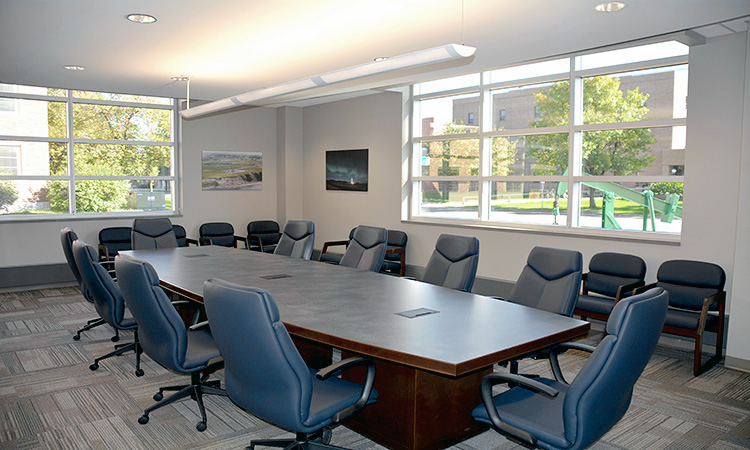 A bright sunny office with a conference table and chairs.