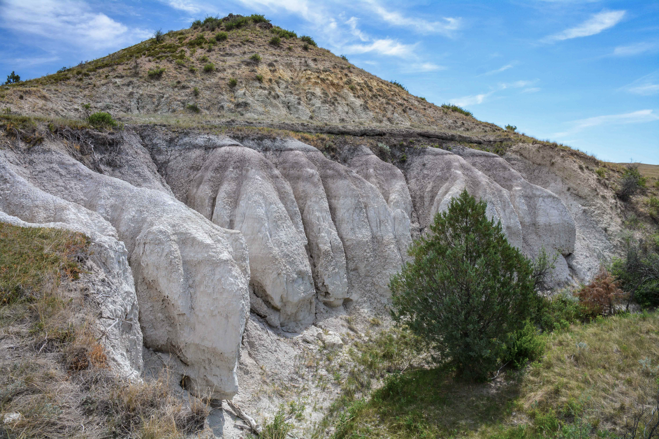 Photo of a rock formation against blue sky.