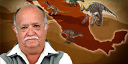 Rene standing in front of a map with dinosaurs from Mexico