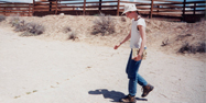 A young Becky walking near dinosaur footprints in Wyoming