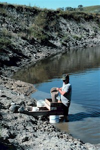 Mike Hanson screen washing Gregory Member claystone for fossils along the Sheyenne River.