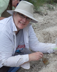 Trissa working in the field, smiling