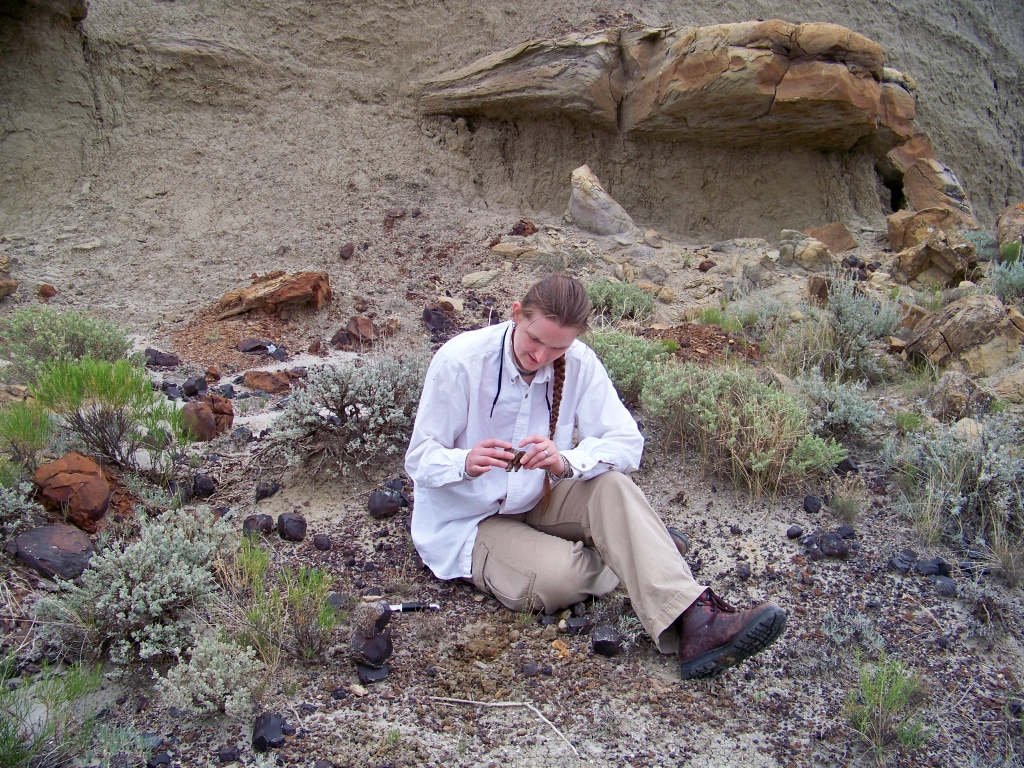 Paleontologist Becky Barnes examining some fossil bearing rocks