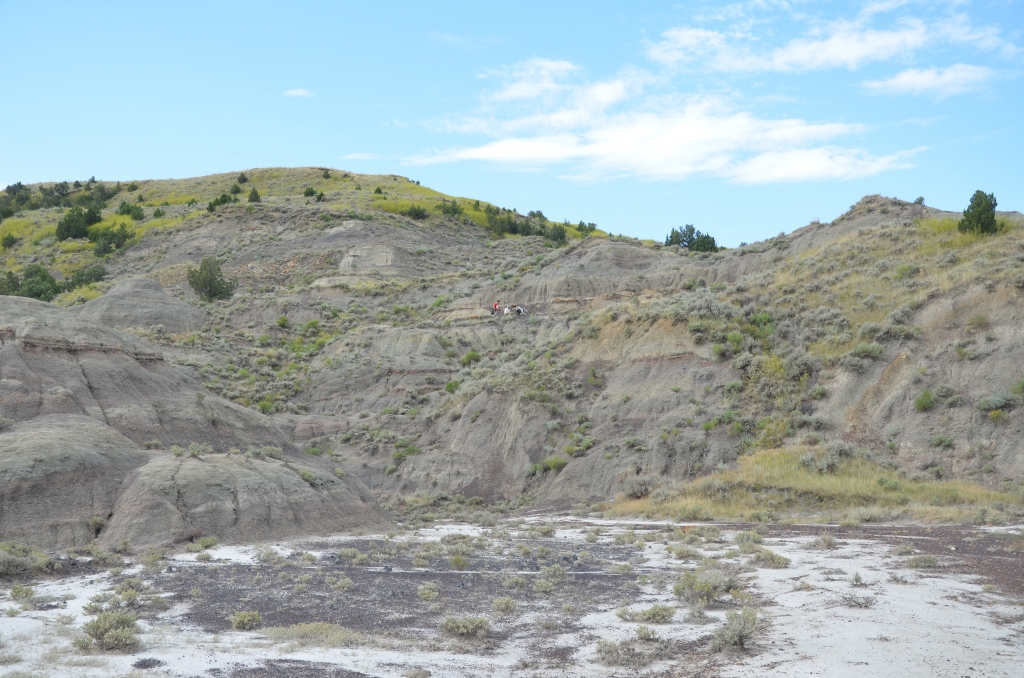 Diggers high up on a butte, prospecting for fossils in the Marmarth area