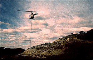 Figure 22d. Field jacket containing champsosaur skeleton being air-lifted from the excavation site. Photograph by Bruce Kaye, Theodore Roosevelt National Park.