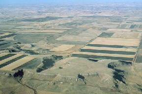Aerial photograph of White Butte in northern Hettinger County. White Butte is typical of the twenty or so flat-topped, white rimmed buttes in this area. 
								These buttes are capped by 1 to 10 foot thick beds of freshwater carbonates that occur in the South Heart Member of the Chadron Formation. 