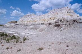 The Rhame Bed, shown here near Deep Creek in northern Slope County, is another brightly colored kaolinitic bed. The 20 to 30 foot thick 
								Rhame bed is present approximately 1200 feet below the Bear Den Member. Both the Rhame Bed and the Bear Den Member are thought to have resulted from extended or intense periods of weathering. 