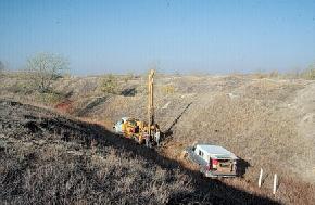 The North Dakota Geological Survey obtaining sediment cores from spoils in the Noonan mine. The spoils in this part of the mine were created in the mid-to late 1940s. There has been some interest expressed in leveling the old spoil piles that occur throughout western North Dakota, especially some of the larger mines. A study of the groundwater conditions and the natural salts within the spoil piles in the early 1980s recommended that they be left as they are because leveling of these areas would adversely impact the quality of the underlying groundwater. In addition, these mines provide cover, albeit sometimes sparse, for wildlife. In fact, portions of several of these old mines are managed by the North Dakota Game and Fish Department. 