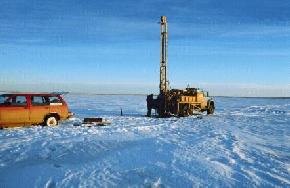 There are only a few ways to obtain sediment samples from beneath these lakes: hand augering in the late fall, 
								drilling from a floating platform (barge) during the summer, or drilling with a truck mounted rig in the winter when the lake has sufficiently frozen. The North Dakota Geological Survey 
								chose to drill in the winter and had to contend with temperatures that ranged from 30 to -24 degrees Fahrenheit). (Photo by E. Murphy, NDGS). 