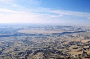 A large terrace is present above the Little Missouri River just east of Bullion Butte in Billings County. 
								The terrace is present near the center of this oblique aerial photograph and is surrounded by badland topography. The sand and gravel capped terrace stands approximately 200 feet above the 
								Little Missouri River and occupies and area of about 3 square miles.(Photo by E. Murphy, NDGS).